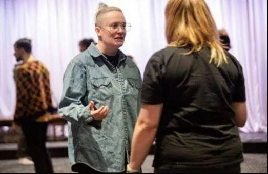 Two actors talking through a scene in rehearsal